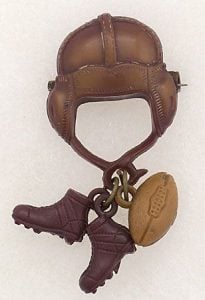 Bakelite tends to be dark colors, such as with this dark brown football pin.