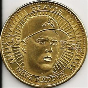1998 Pinnacle Coin Greg Maddux.  Issued as inserts in their sports packs, Pinnacle included brass, silver and ultra rare genuine gold coins.